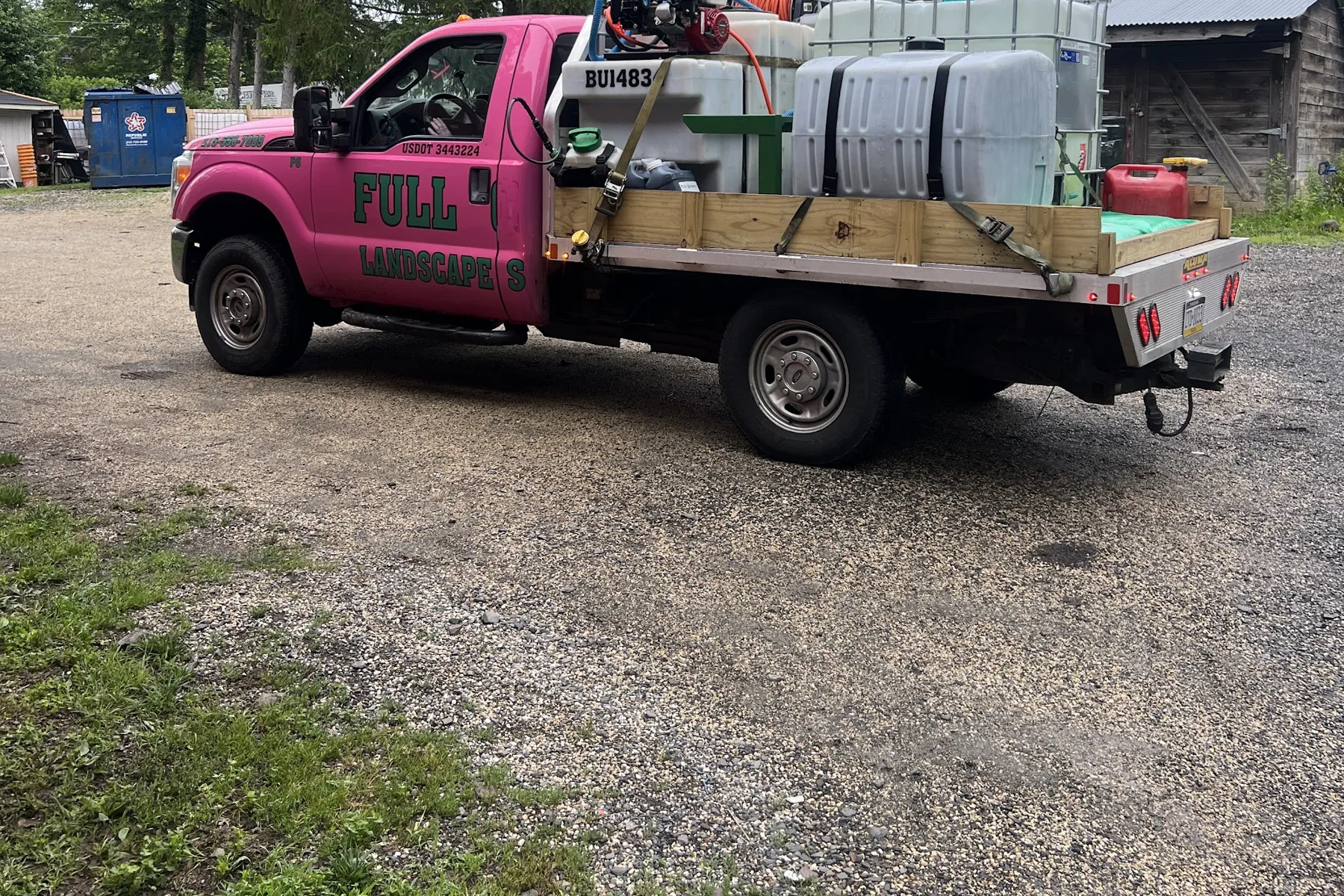 Full Circle Services pink lawn care truck with spray equipment