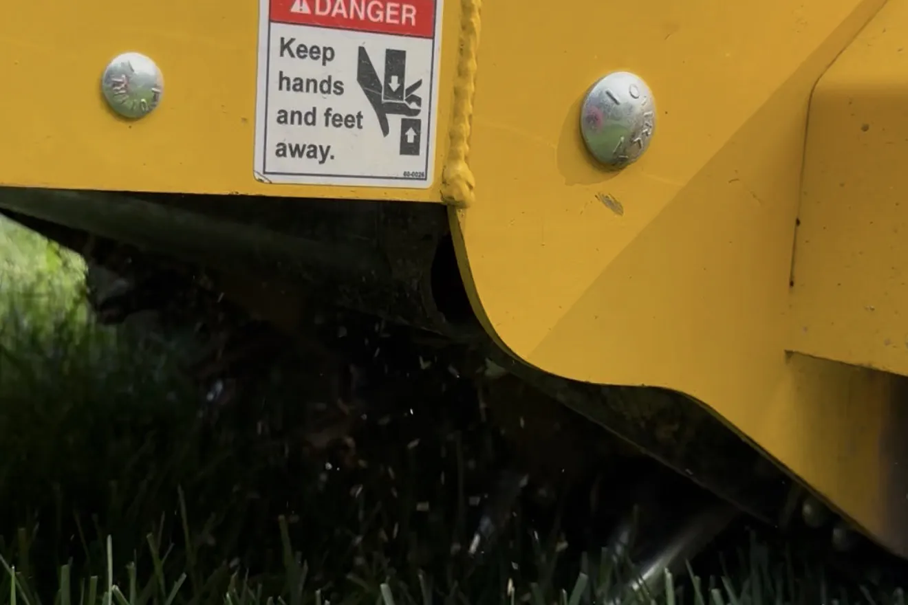 Core aeration machine pulling plugs from a lawn in Bucks County, PA